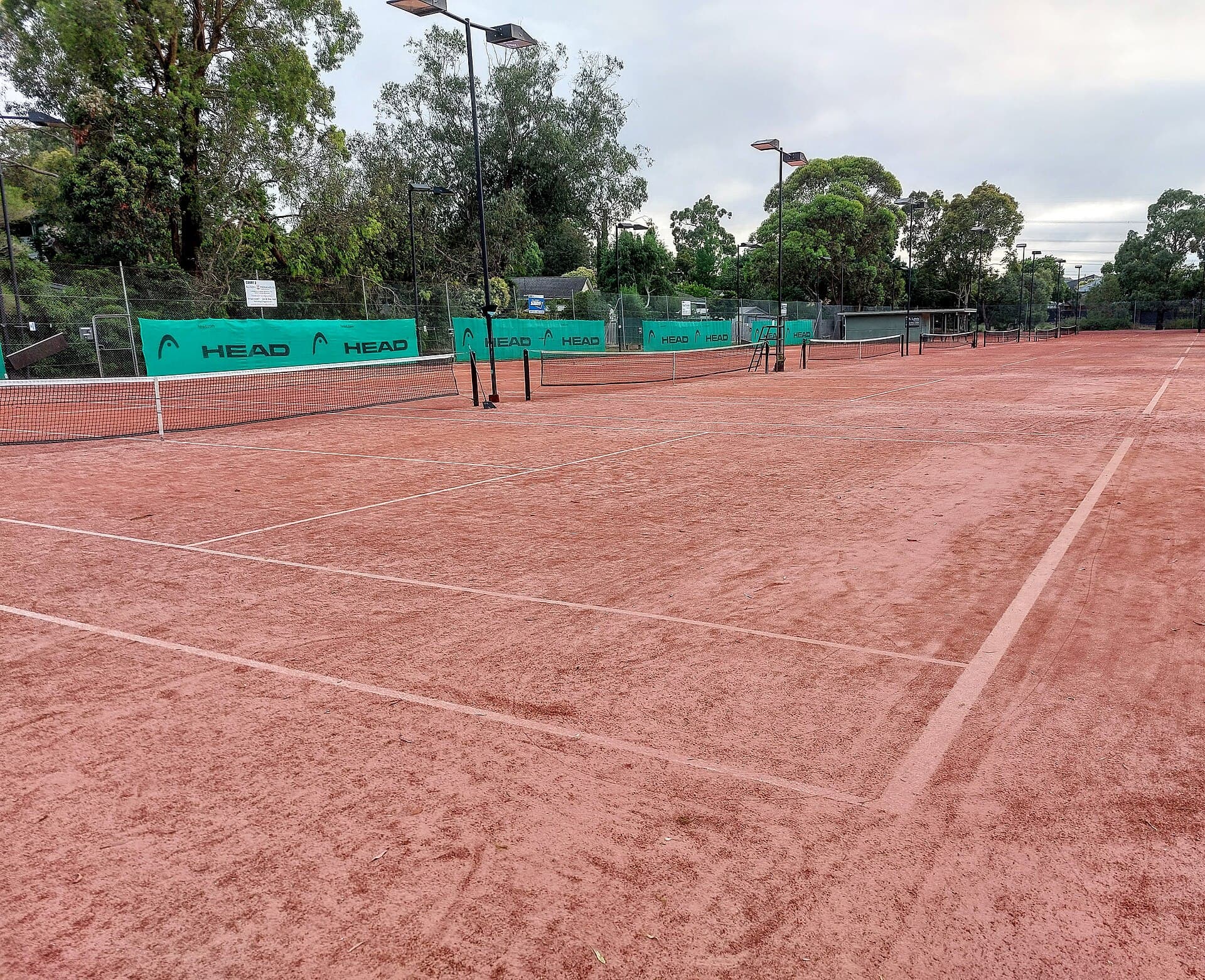 Club clay tennis courts on a sunny day