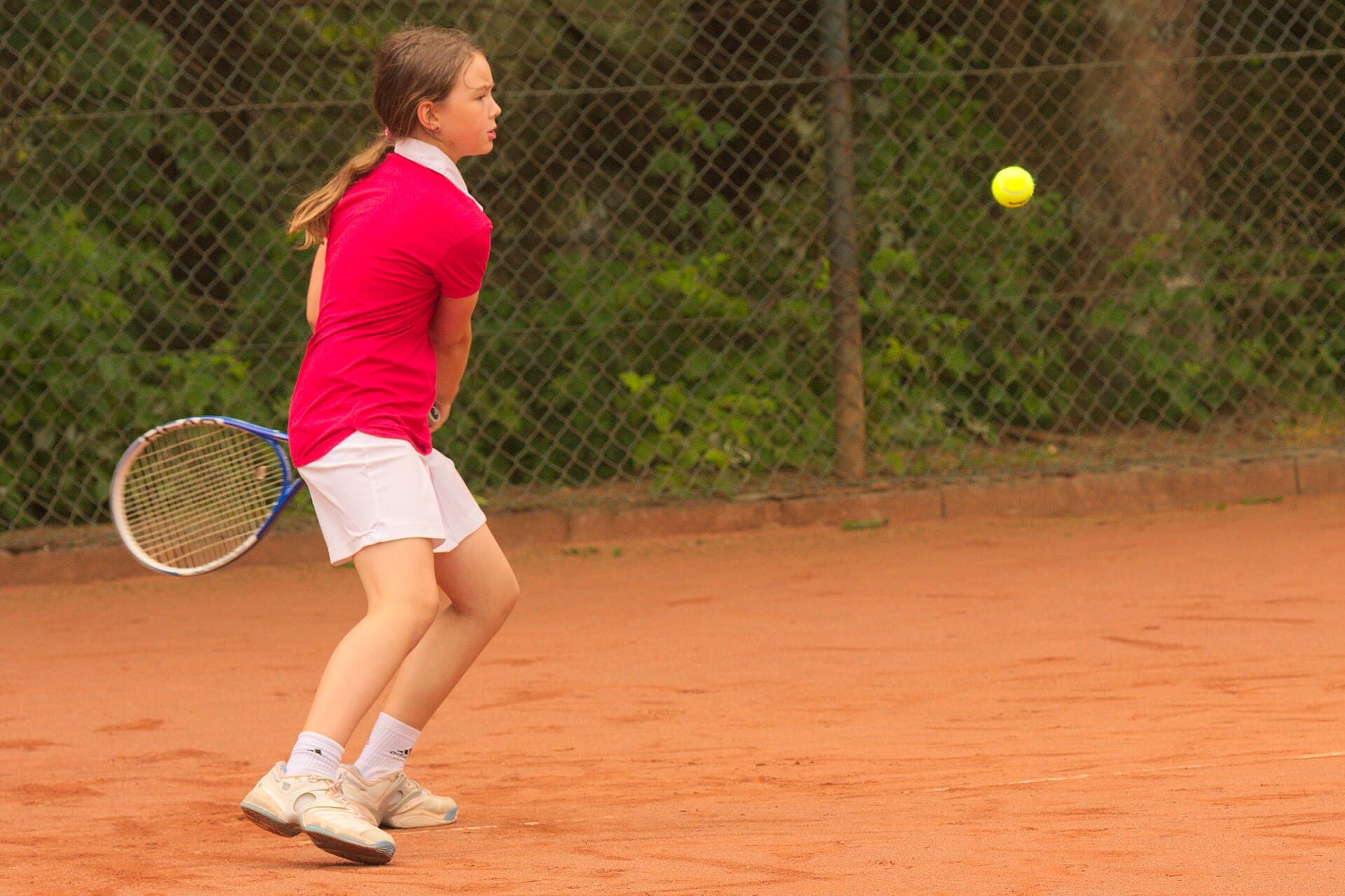 Junior player hitting a forehand in training