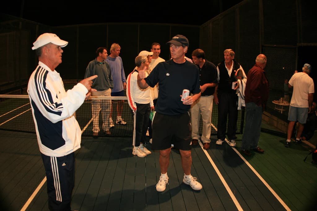Platform tennis players rallying on court