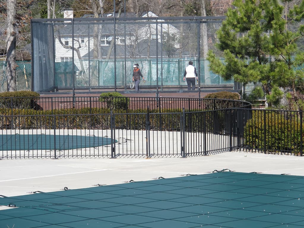 Platform tennis players competing on a club court in winter